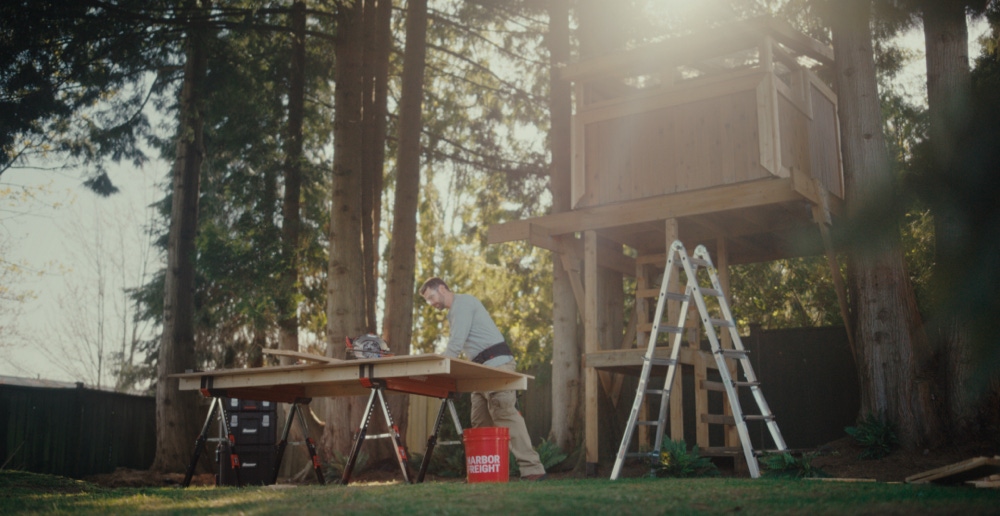 Man building a treehouse using Harbor Freight Tools
